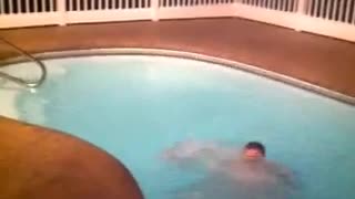 Guy trying to jump from one side of the pool to the other