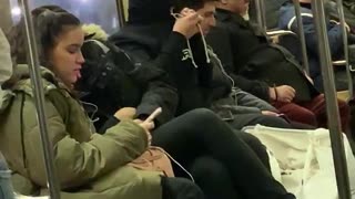 Guy ties up hoodie over face and goes to sleep on subway