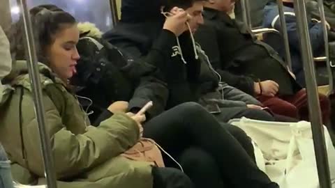Guy ties up hoodie over face and goes to sleep on subway