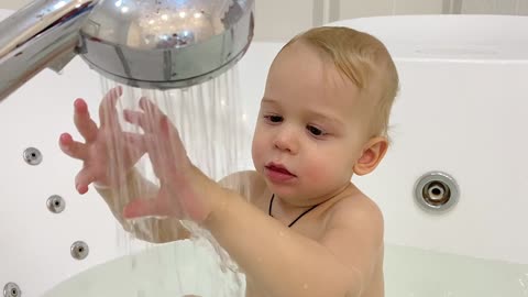 kid discovering shower world