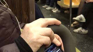Man on subway dog on blue harness