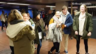 Women dancing and singing to man playing jackson 5