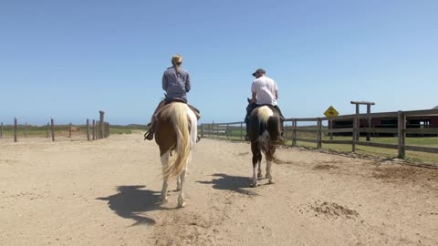 Couple Riding Horses on Ranch