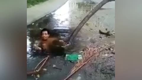 Guy Cooling Off in the Street Sewer Spa