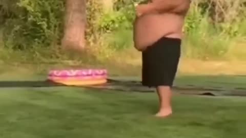 big guy gets taken out by a blow up ball booted at him