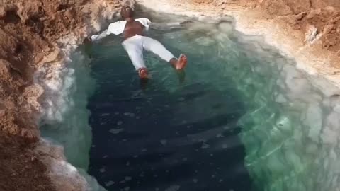 Floating in the salt water siwa osasis in Egypt