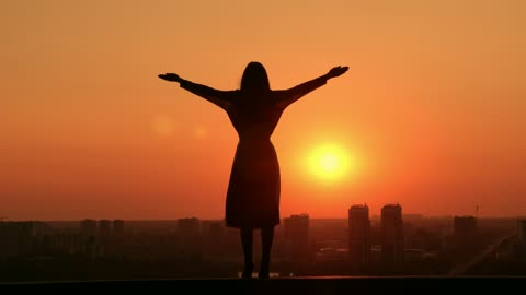 Woman during a sunset on a rooftop