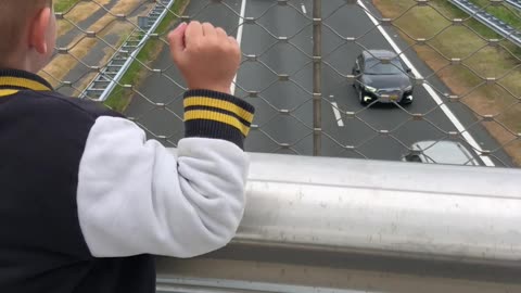 Boy Waves to Truckers