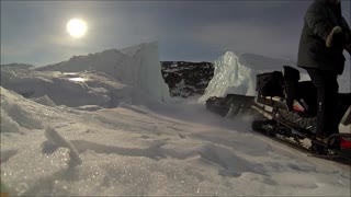 Driving Snowmobile Through Iceberg