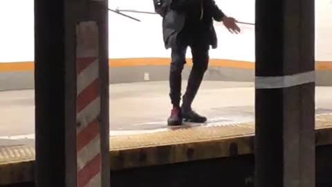 Subway goer dances to the voice of the lady speaking on subway intercom