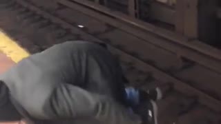 Drunk man and woman walk through nyc subway train tracks, very dangerous