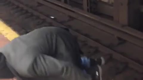 Drunk man and woman walk through nyc subway train tracks, very dangerous