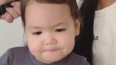 Baby collaborating with parents for singing song