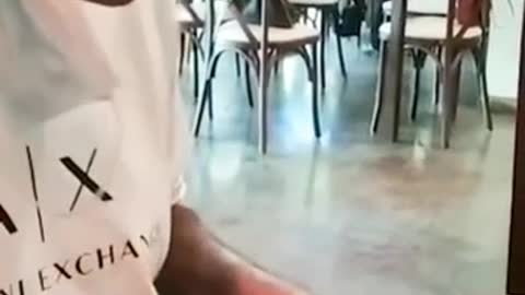 Guy trying to eat his napkin at the restaurant