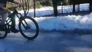 Kid Rides Bike On Frozen Ice, Slips And Falls