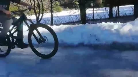 Kid Rides Bike On Frozen Ice, Slips And Falls