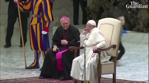 Pope Francis chuckles as boy climbs on stage and interrupts speech
