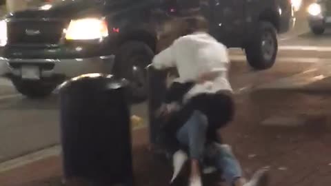 Girl jumps on girl and falls into black car blocker