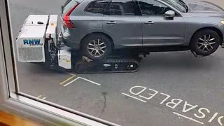 Robot removes car from disabled parking spot