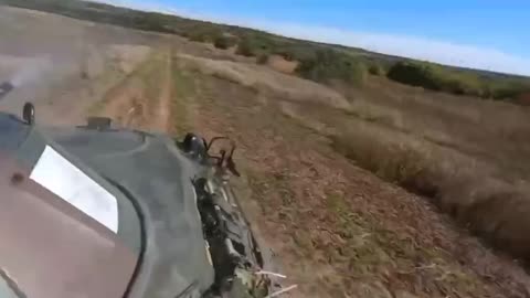 Flight of a Russian ATGM next to a Ukrainian armored personnel carrier.