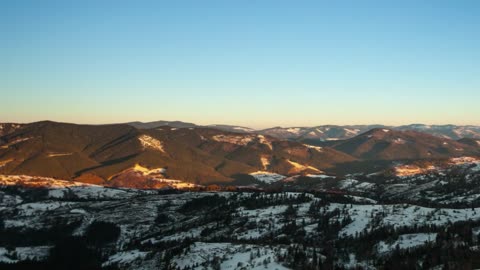 Starry sky during sunrise in the mountains