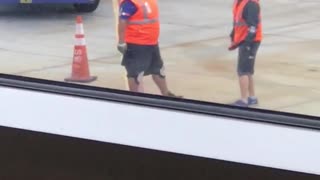 Two men orange airport dancing