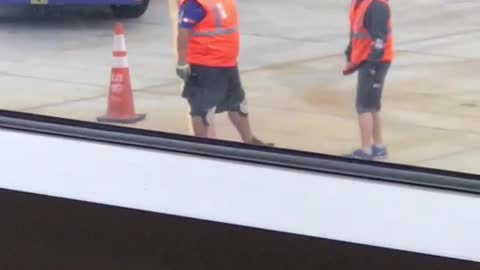 Two men orange airport dancing
