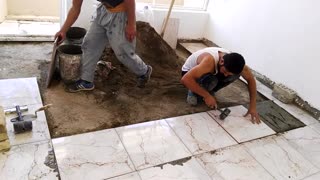 Mason and labor doing Tile working at home to make home attractive