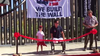 Benton Stevens and Brian Kolfage does the ribbon-cutting for new wall