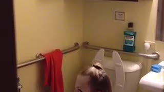 Guy in grey shirt throwing up in bathroom