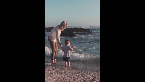 Mother And Son Playing On The Seashore
