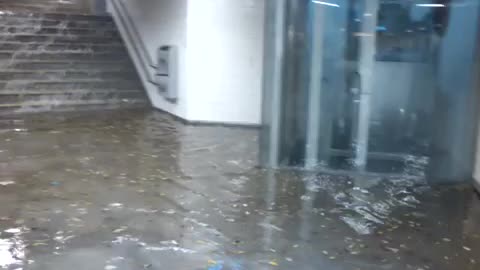 Flood waters going down stairs into subway