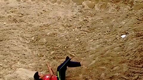 Kid in red shirt black pants backflip fail onto dirt