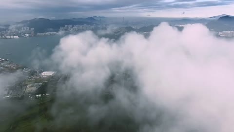 Drone in clouds with City view