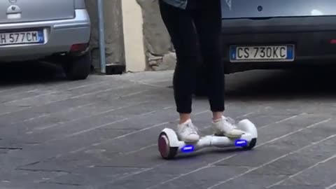 Girl on white hoverboard fail purple wheels