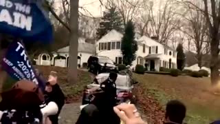 Cuomo's house and sings "We will rock you"