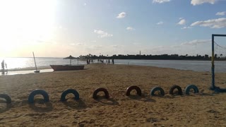 Boys Play On Beach With Sunset View Of Nature