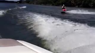 Red shorts wake board faceplant