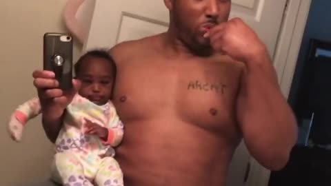 Multitasking dad shows us how he brushes his teeth while holding the baby