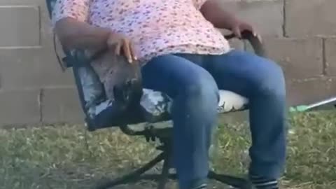 Funny grandma falling while sitting on a chair