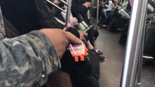 Big man on subway plays tiny xylophone