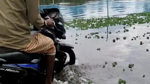 Water in ride motorbike. flood effect by road. Motorcycle ride on water. very watar on road