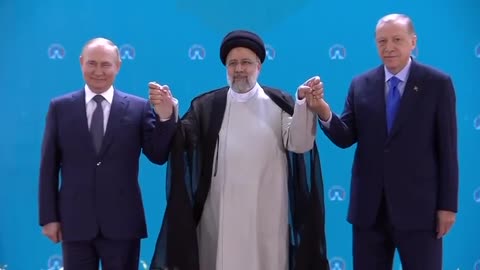 Putin, Raisi, and Erdogan holding hands in Iran.