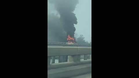 A vehicle on fire on the Bonnet Carre following a helicopter crash