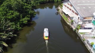On Top of a Passenger Power Boat while flying my drone in Southeast Asia in a watery canal