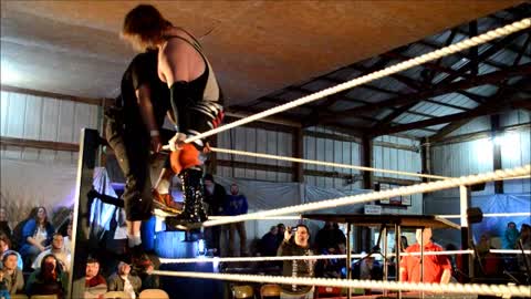 Suplex thru table covered in Thumb Tacks