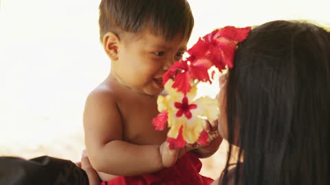 A Boy Removes The Woman Headdress