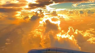A plane flying above the clouds in a mesmerizing sunset view