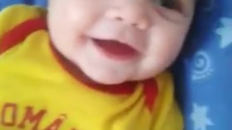 Sweet baby laughing at toy rattle