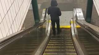 Man walking on escalator going backwards